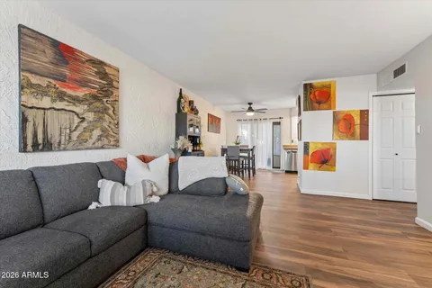 a living room with furniture and wooden floor