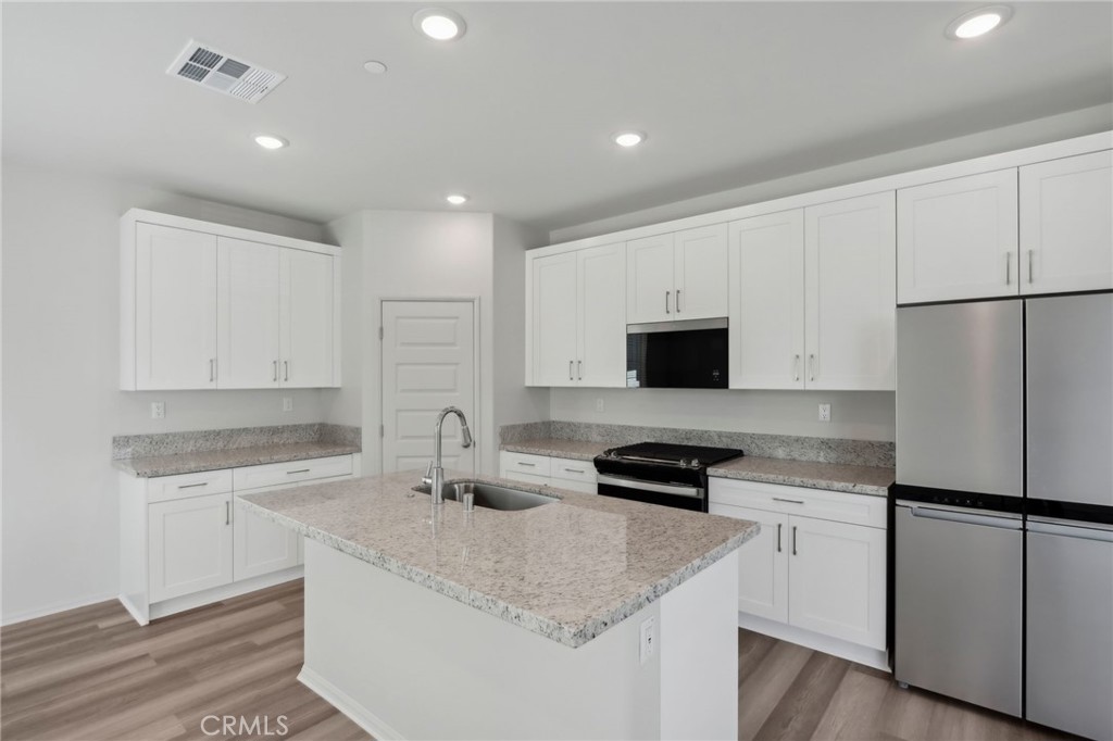 29527 Via Cosecha Temecula, CA 92591 - Photo 12 of 35 a kitchen with a sink a stove and refrigerator