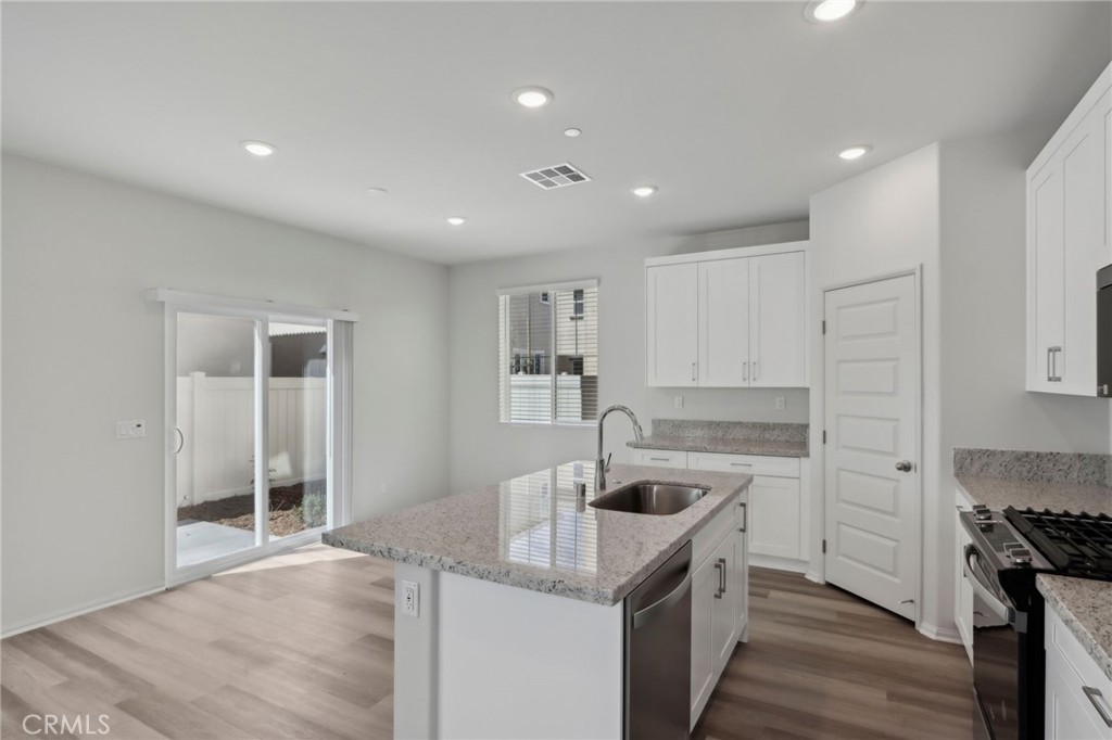 29527 Via Cosecha Temecula, CA 92591 - Photo 13 of 35 a kitchen that has a sink and a stove in it