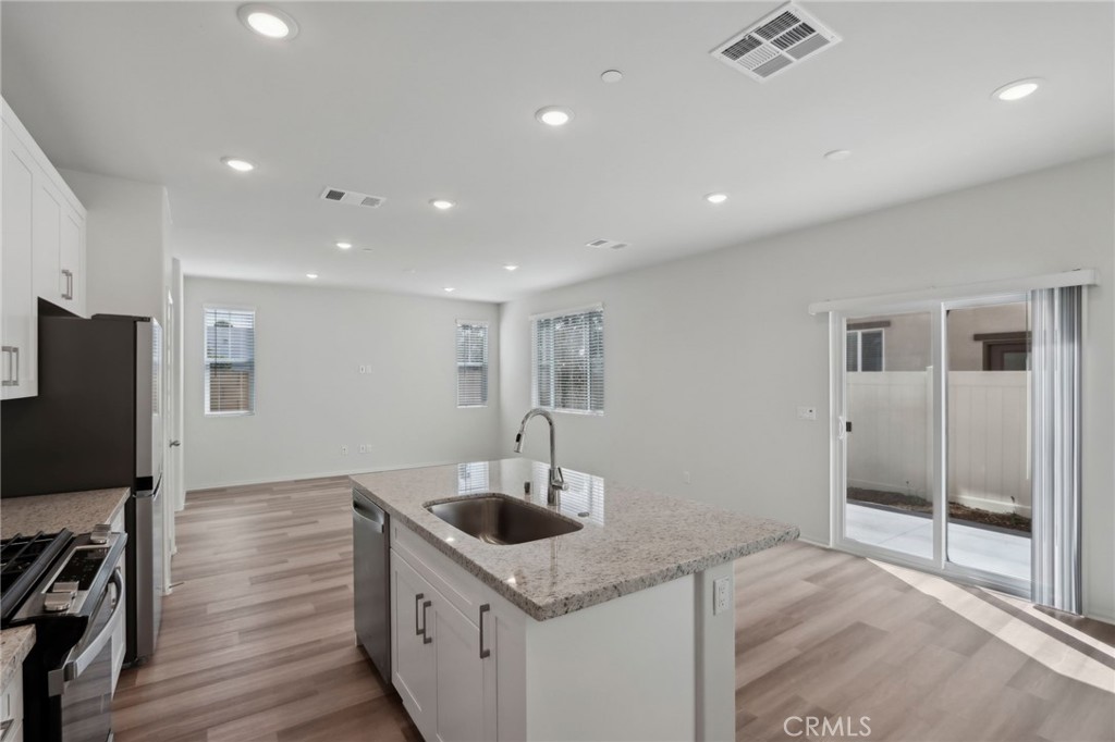 29527 Via Cosecha Temecula, CA 92591 - Photo 14 of 35 a kitchen with stainless steel appliances granite countertop a sink and a refrigerator