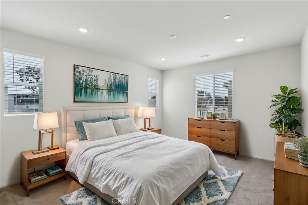 29527 Via Cosecha Temecula, CA 92591 - Photo 17 of 35 a bedroom with a bed and a potted plant