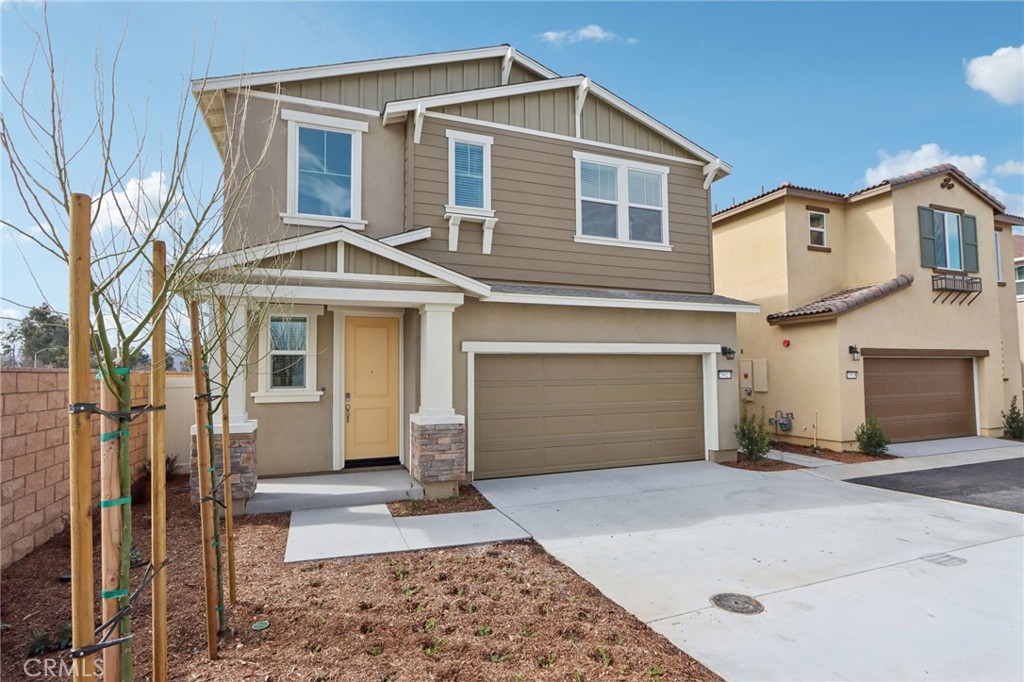 29527 Via Cosecha Temecula, CA 92591 - Photo 2 of 35 a front view of a house with a yard and garage