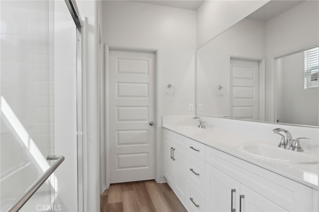29527 Via Cosecha Temecula, CA 92591 - Photo 21 of 35 a bathroom with a double vanity sink and mirror