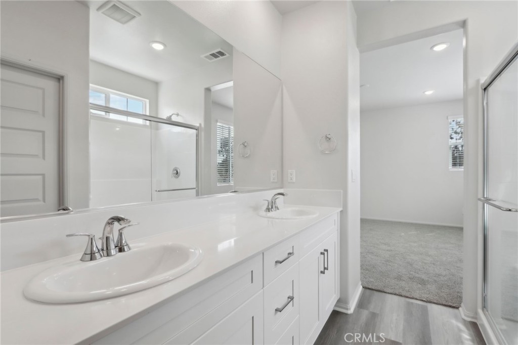 29527 Via Cosecha Temecula, CA 92591 - Photo 22 of 35 a bathroom with double vanity sinks and a mirror