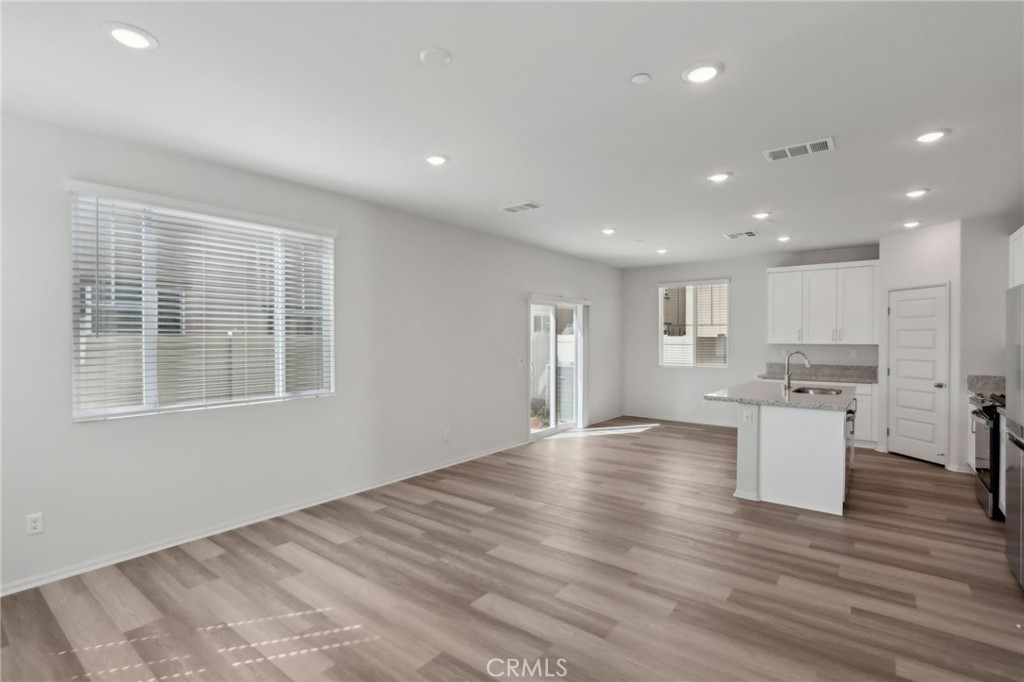 29527 Via Cosecha Temecula, CA 92591 - Photo 5 of 35 a view of a kitchen with a sink and dishwasher a refrigerator with wooden floor