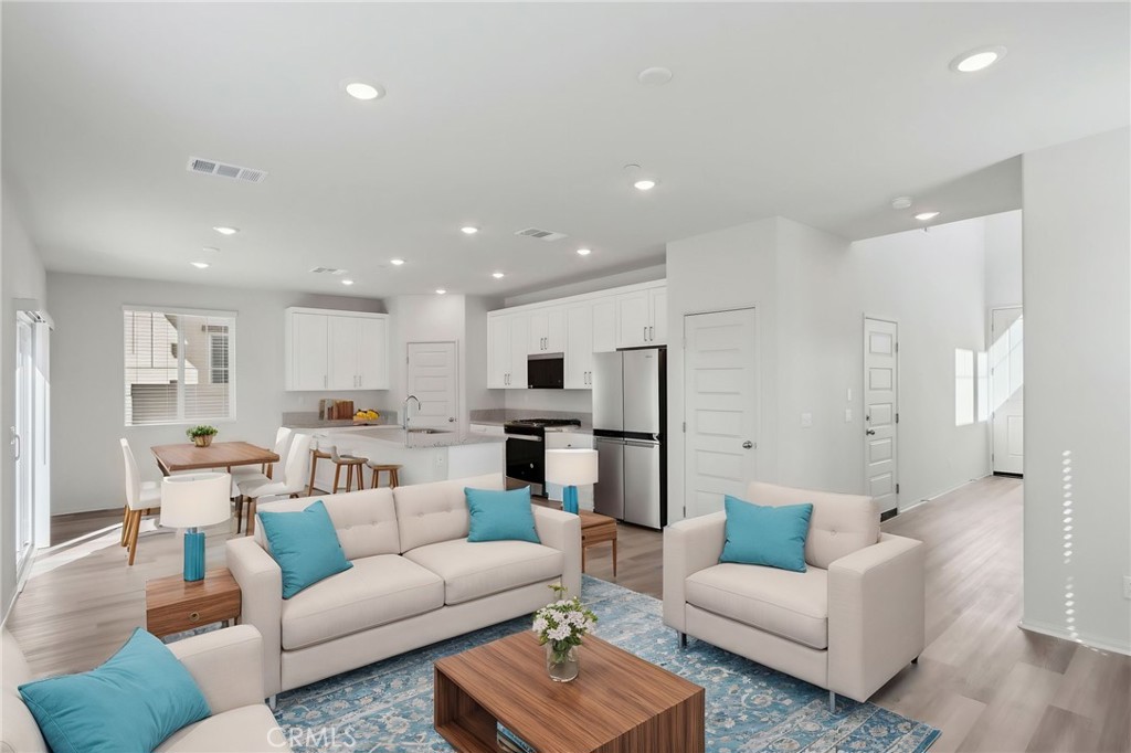 29527 Via Cosecha Temecula, CA 92591 - Photo 7 of 35 a living room with furniture white walls and kitchen view