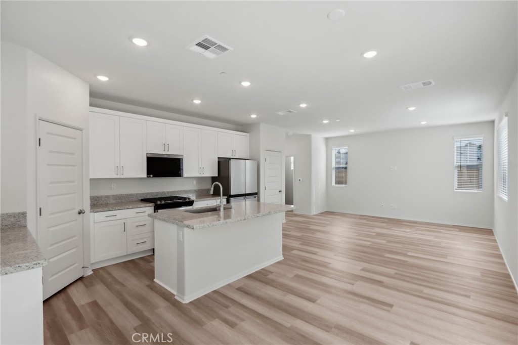 29527 Via Cosecha Temecula, CA 92591 - Photo 9 of 35 a view of kitchen with microwave stove refrigerator and cabinets