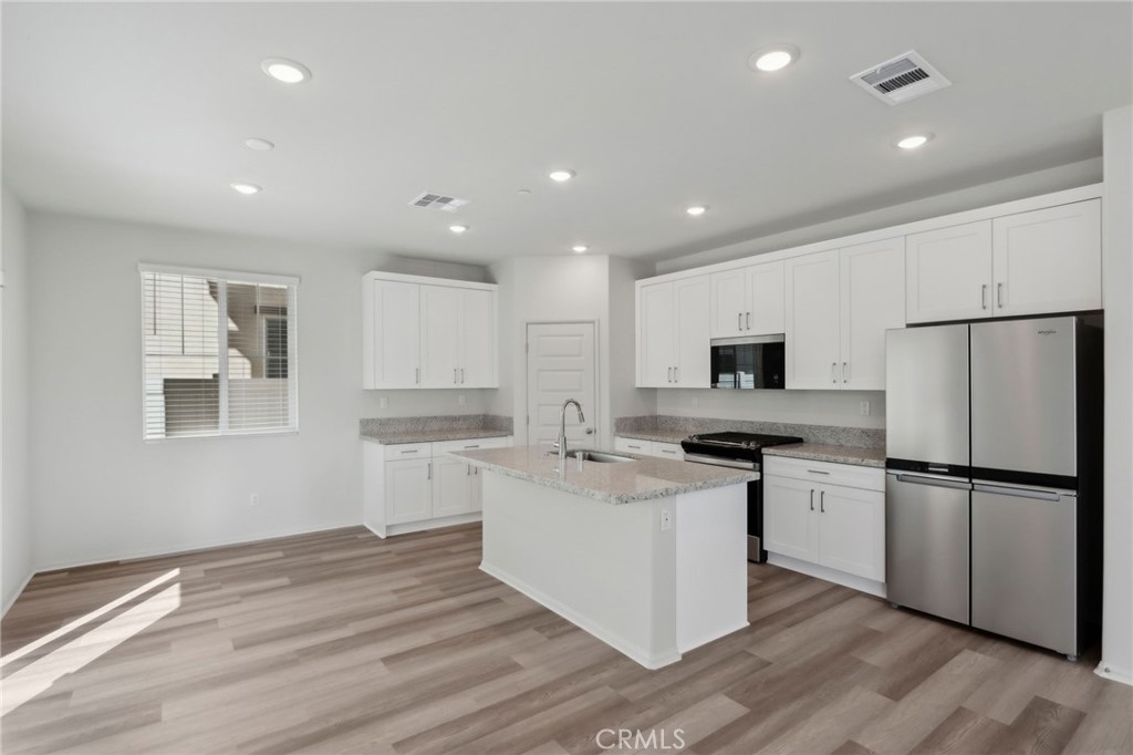29527 Via Cosecha Temecula, CA 92591 - Photo 10 of 35 a kitchen with stainless steel appliances a refrigerator stove microwave and sink