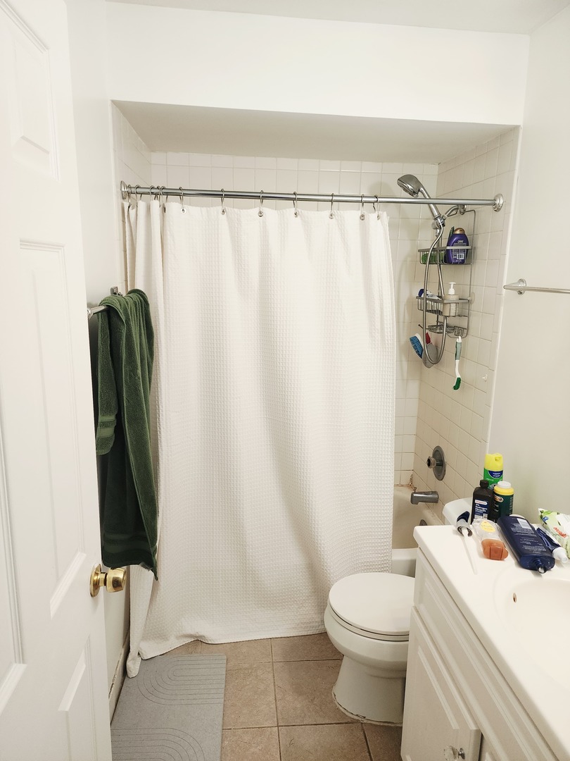 1026 Castilian Court, Unit 113 Glenview, IL 60025 - Photo 11 of 16 a bathroom with a sink toilet and shower