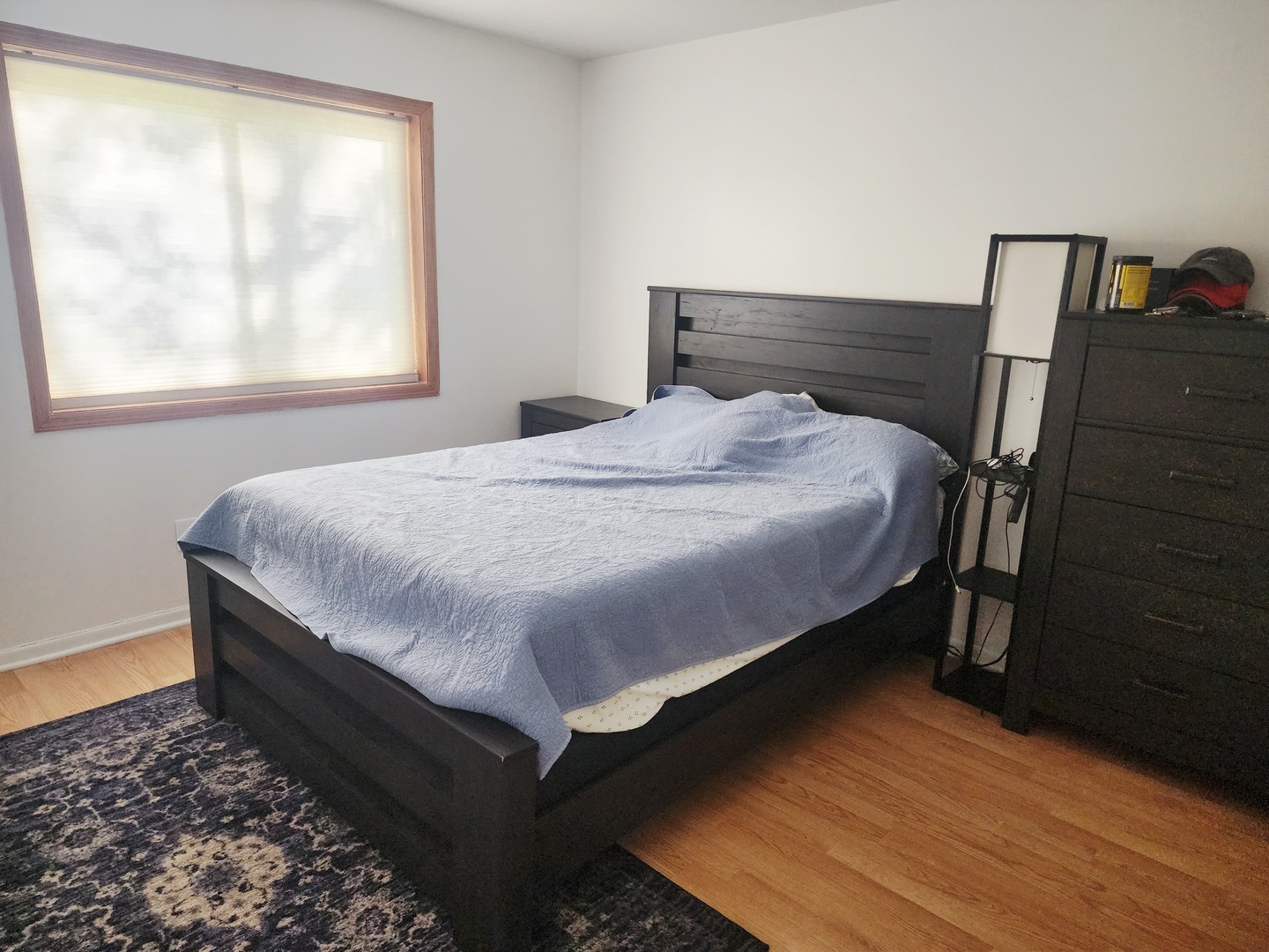 1026 Castilian Court, Unit 113 Glenview, IL 60025 - Photo 12 of 16 a bed sitting in a bedroom next to a window