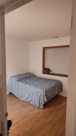 a view of an empty room and wooden floor