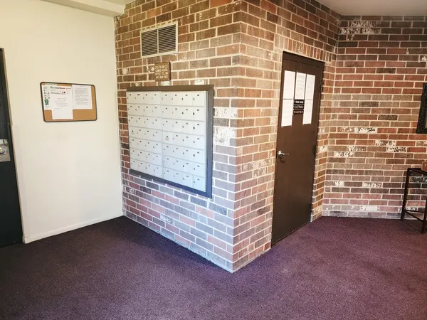 a view of an empty room and wooden door