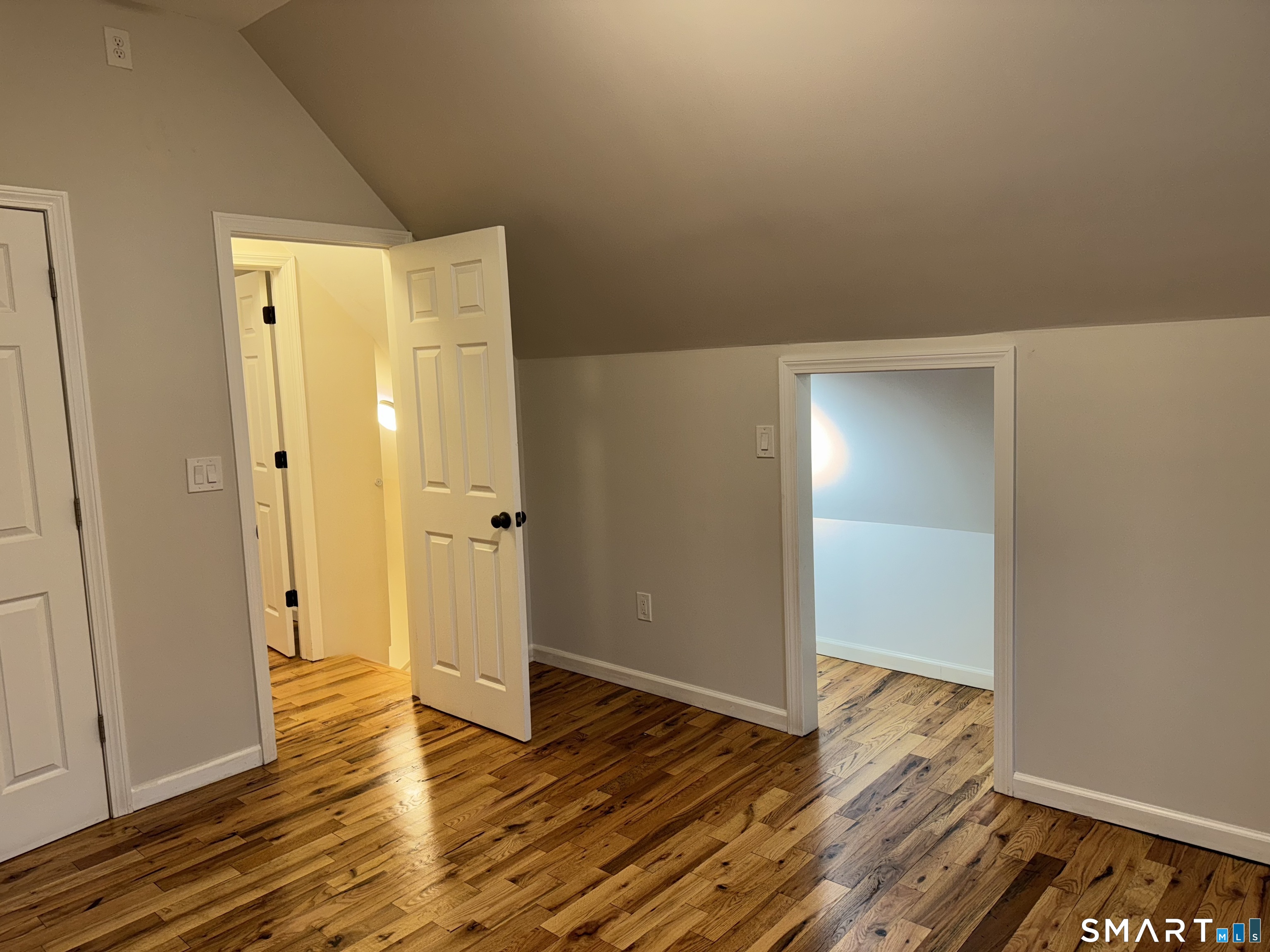 39 Bassett Street Ansonia, CT 06401 - Photo 11 of 21 a view of an empty room with wooden floor and a bathroom