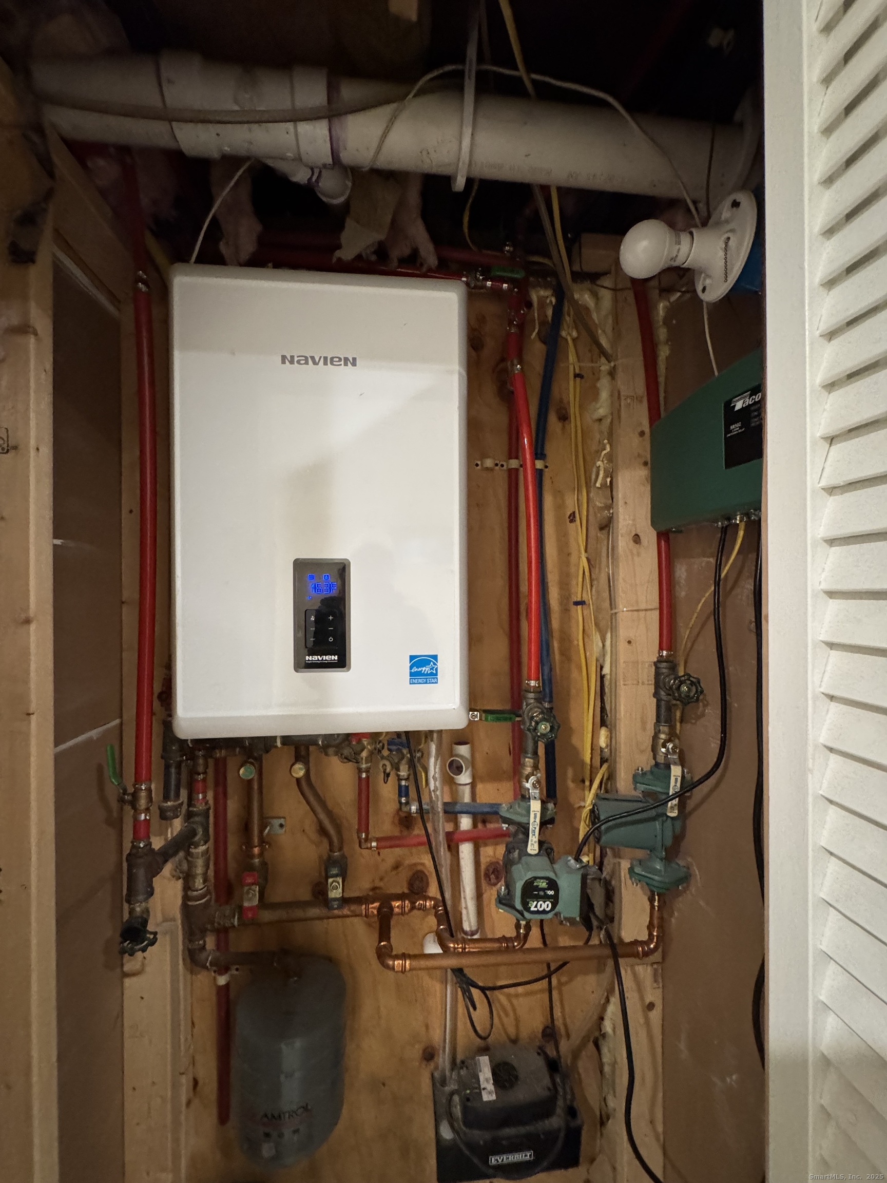 39 Bassett Street Ansonia, CT 06401 - Photo 16 of 21 a view of walk in closet with clothes