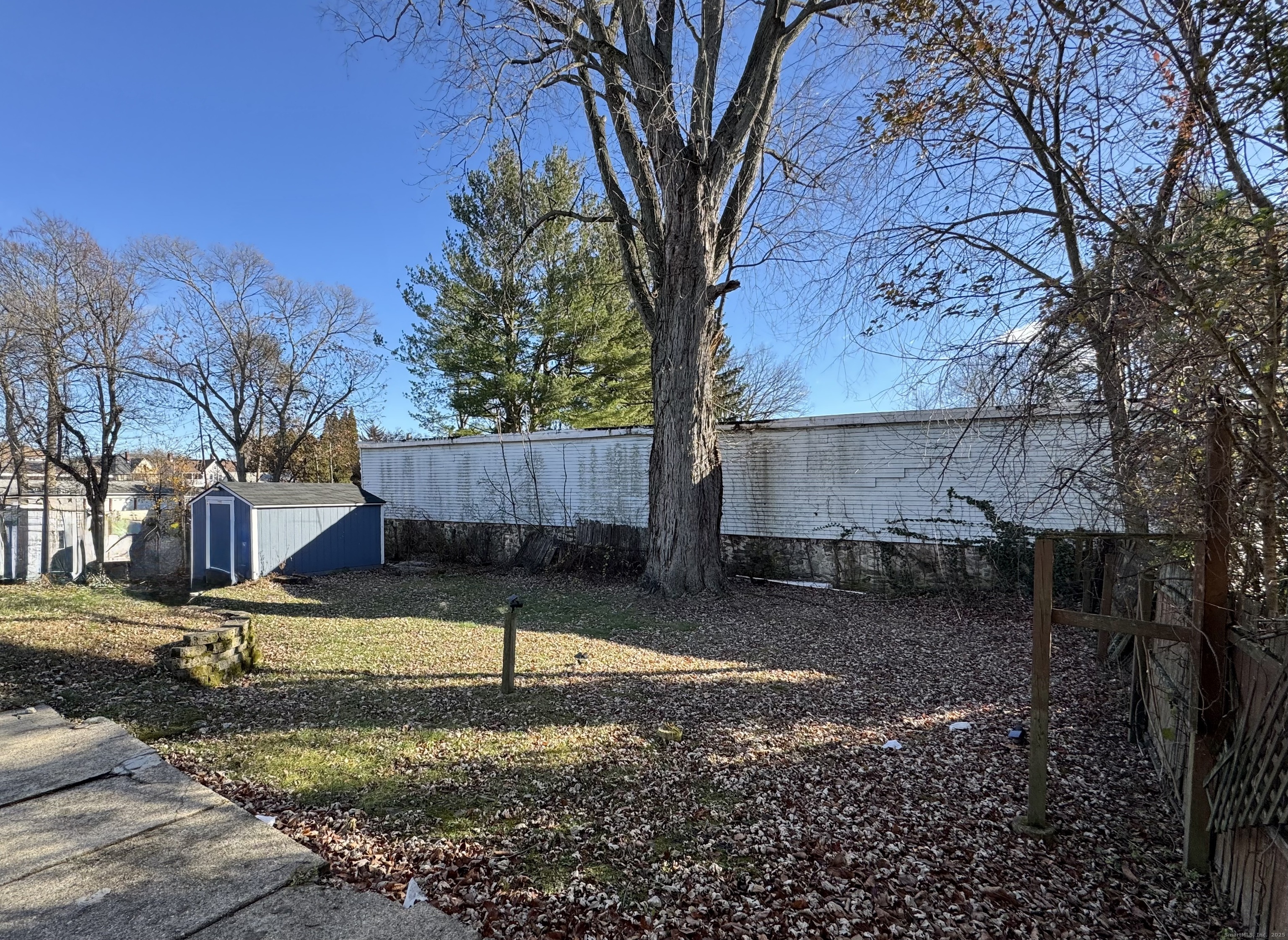 39 Bassett Street Ansonia, CT 06401 - Photo 17 of 21 a backyard of a house with lots of green space