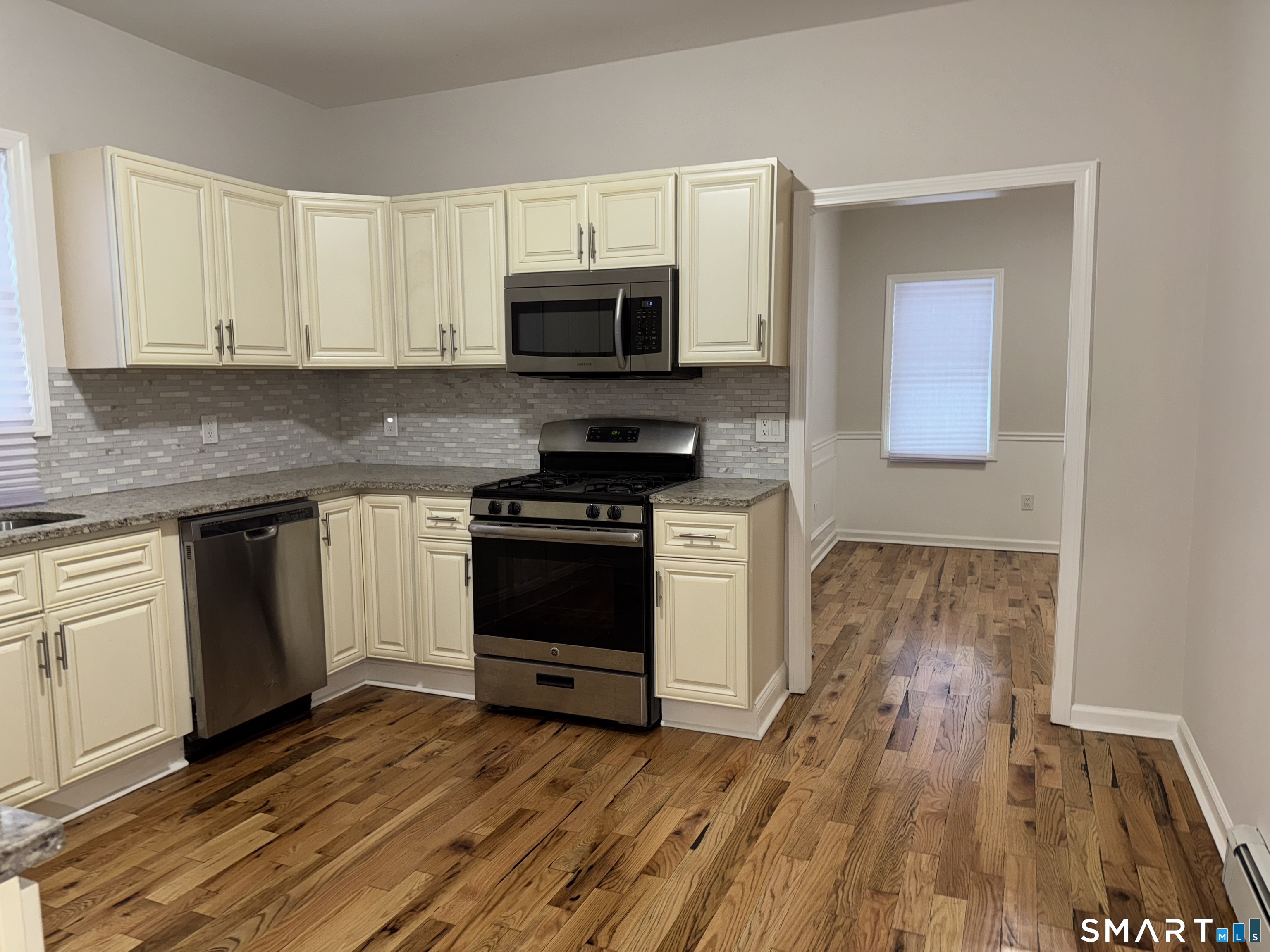 39 Bassett Street Ansonia, CT 06401 - Photo 3 of 21 a kitchen with stainless steel appliances a stove top oven and cabinets