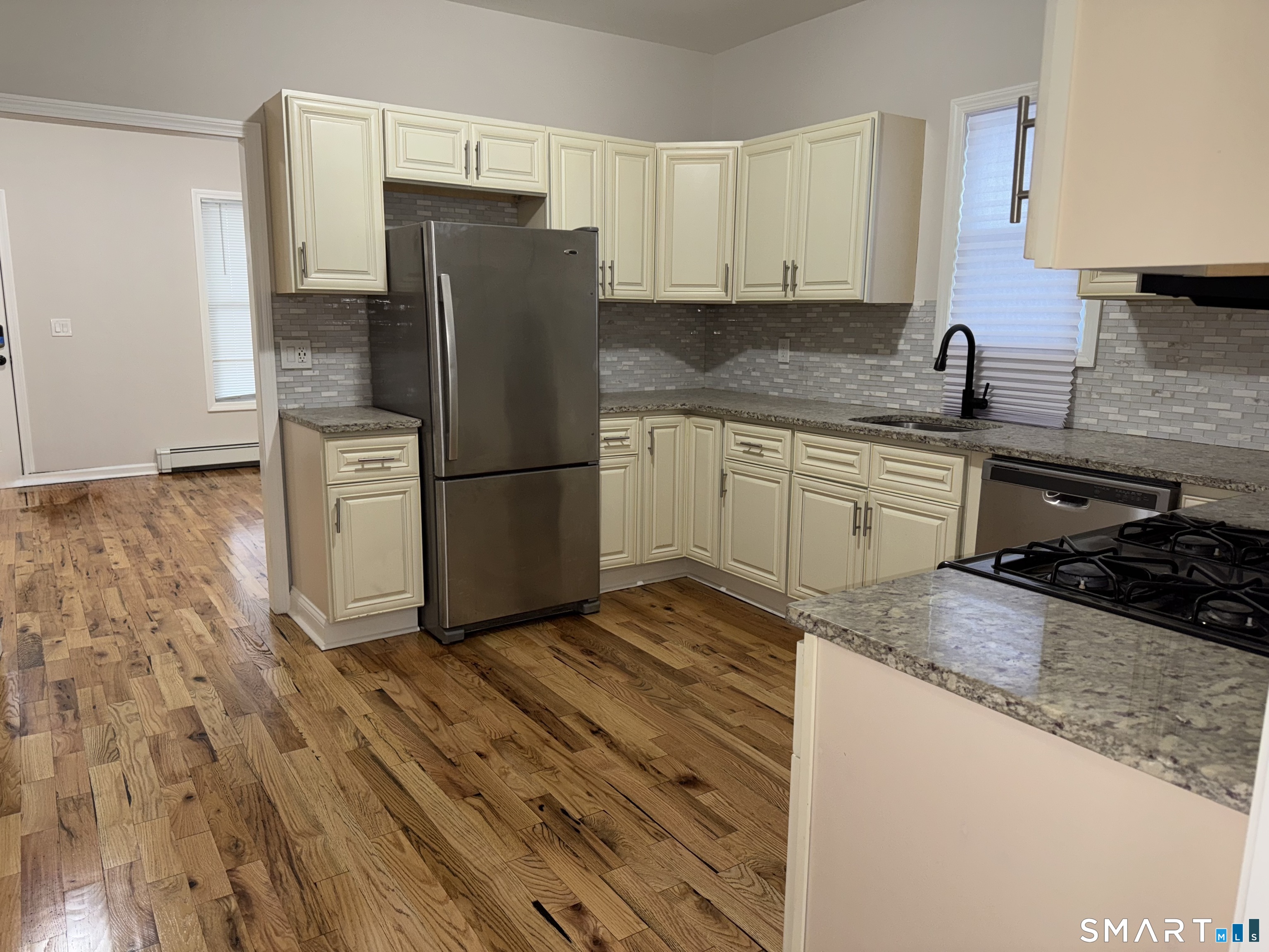 39 Bassett Street Ansonia, CT 06401 - Photo 4 of 21 a kitchen with granite countertop a refrigerator stove and sink