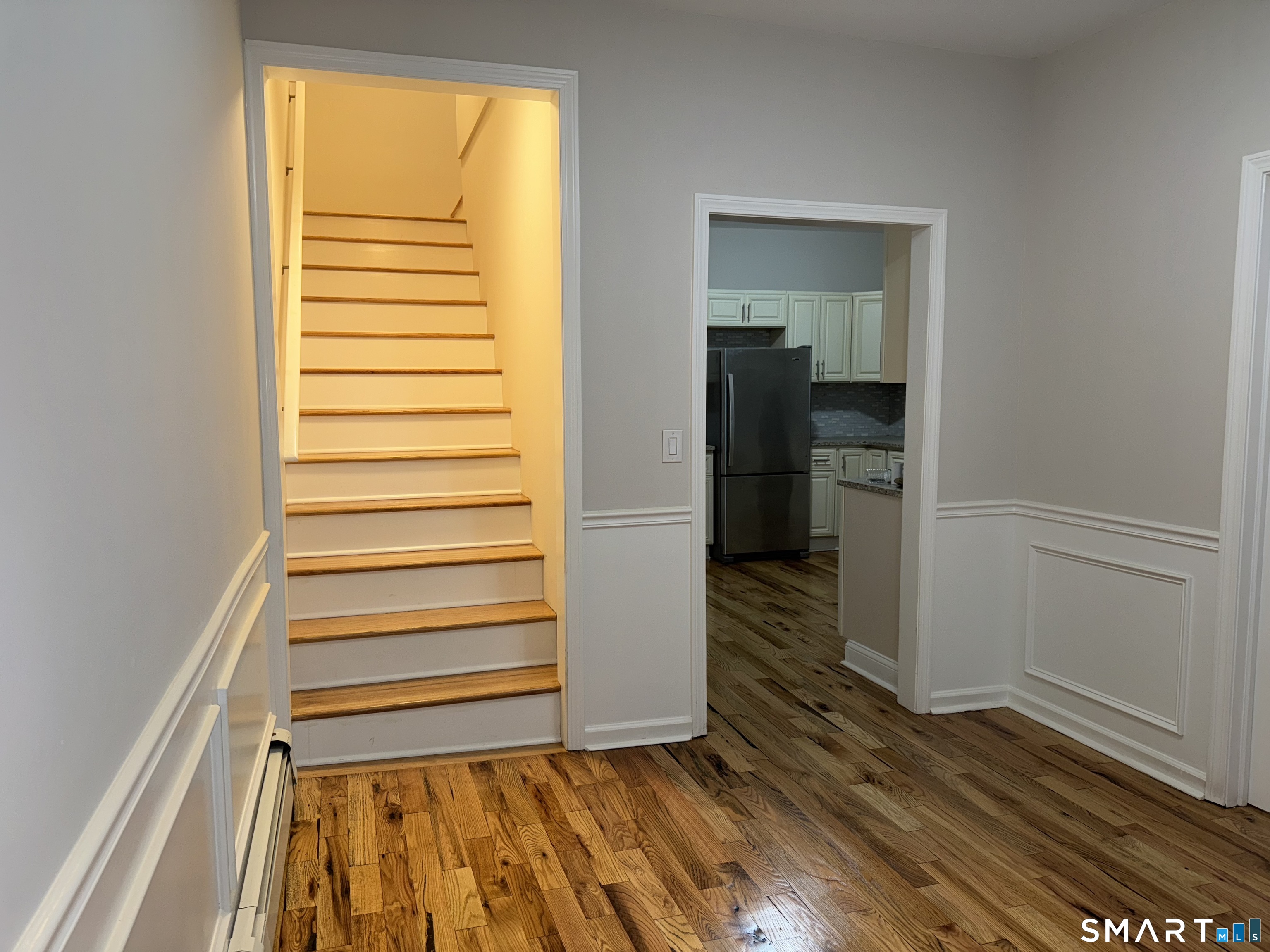 39 Bassett Street Ansonia, CT 06401 - Photo 5 of 21 a view of a room with wooden floor and a window