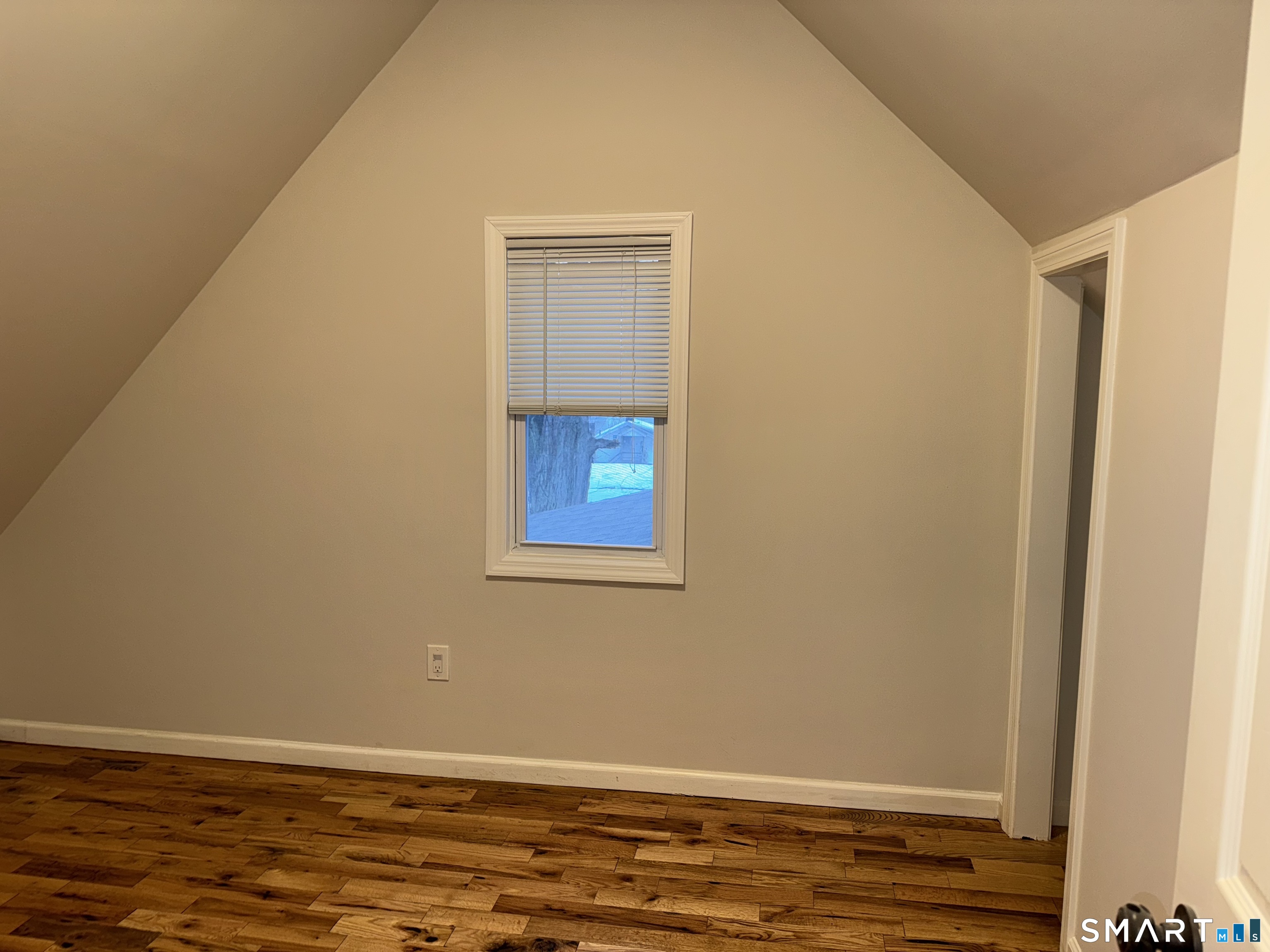 39 Bassett Street Ansonia, CT 06401 - Photo 9 of 21 a view of an empty room with wooden floor and a window