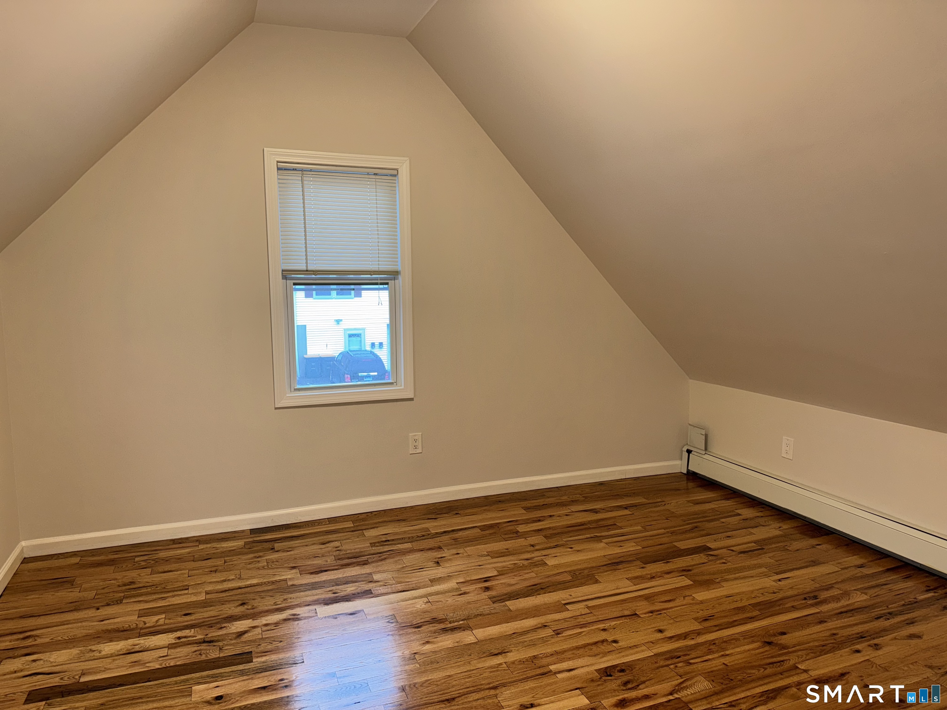 39 Bassett Street Ansonia, CT 06401 - Photo 10 of 21 a view of an empty room with wooden floor and a window