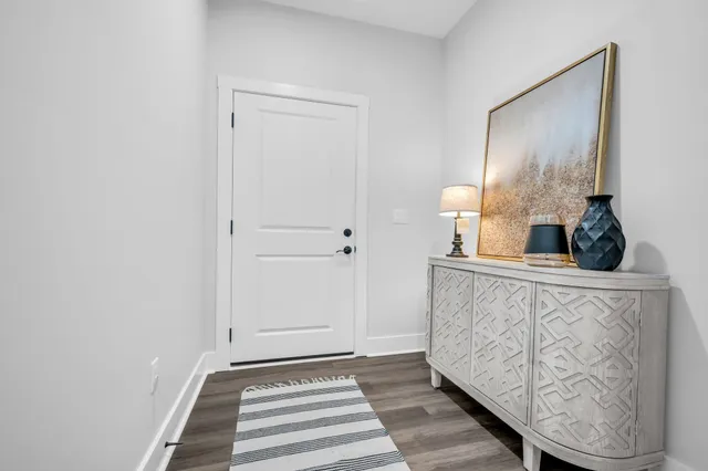 a view of a hallway with wooden floor and staircase