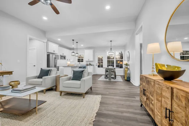a living room with furniture and a wooden floor