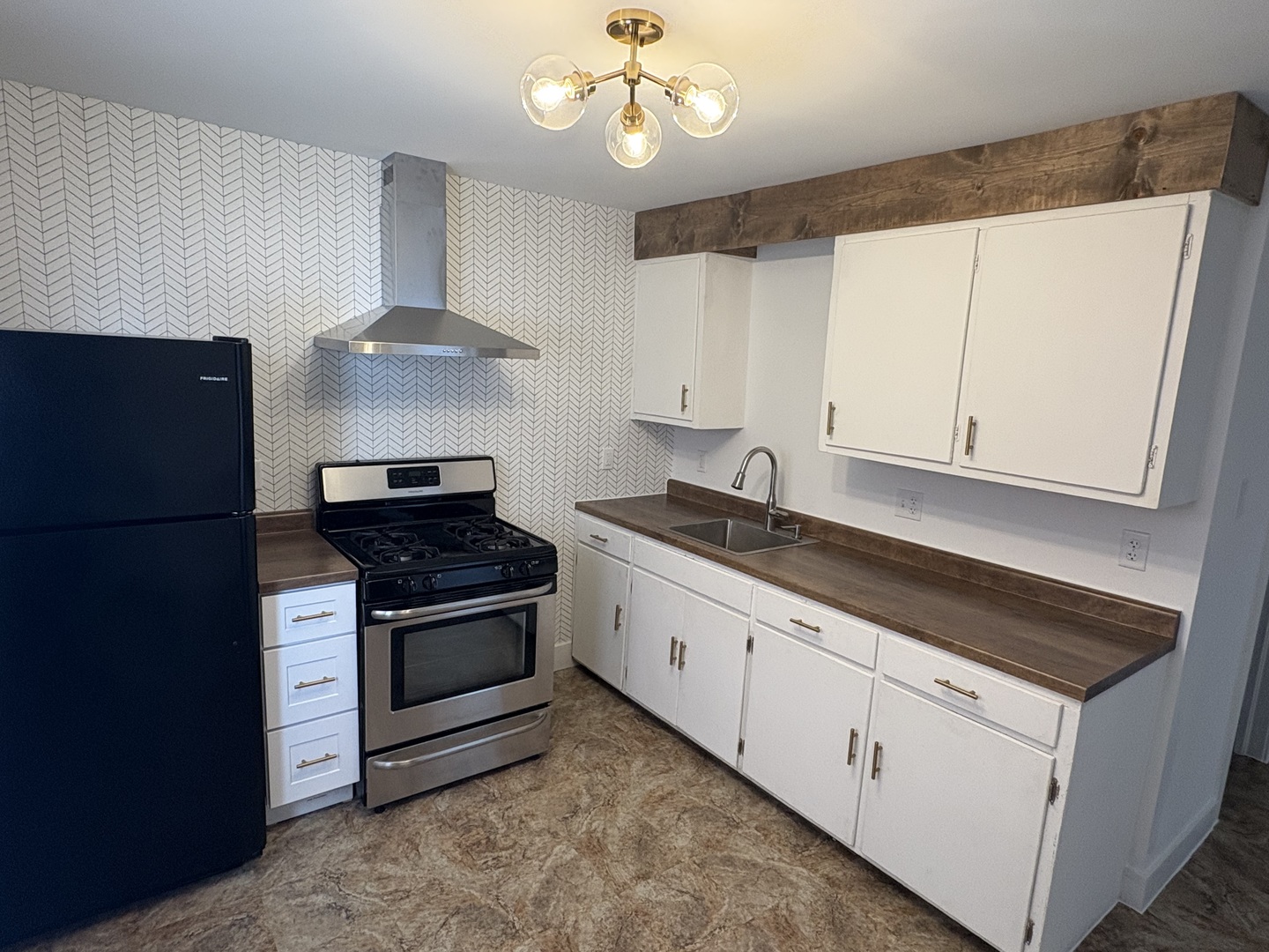 116 North 9th Street DeKalb, IL 60115 - Photo 20 of 20 a kitchen with stainless steel appliances granite countertop a stove a refrigerator and a sink