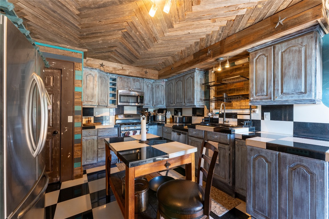3050 Contour Drive Spring Branch, TX 78070 - Photo 11 of 39 a kitchen with stainless steel appliances granite countertop a refrigerator a sink a stove and cabinets