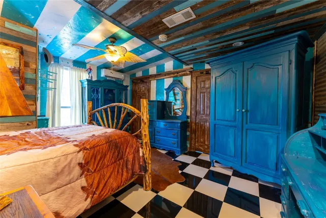 a bedroom with a bed and a large window