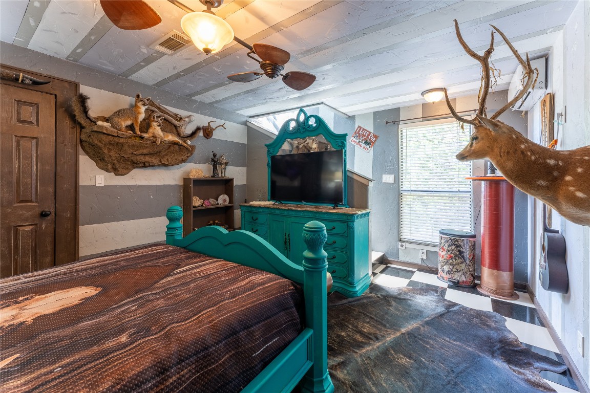 3050 Contour Drive Spring Branch, TX 78070 - Photo 18 of 39 a bedroom with a bed a flat screen tv and a chandelier