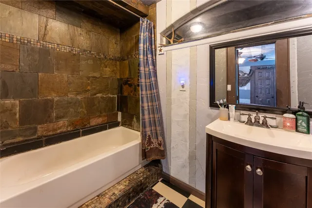 a bathroom with a bathtub and a sink