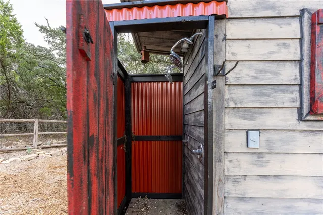 a view of a dry yard with wooden fence