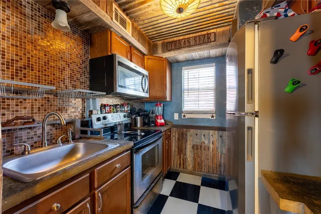 a kitchen that has a sink and a stove in it
