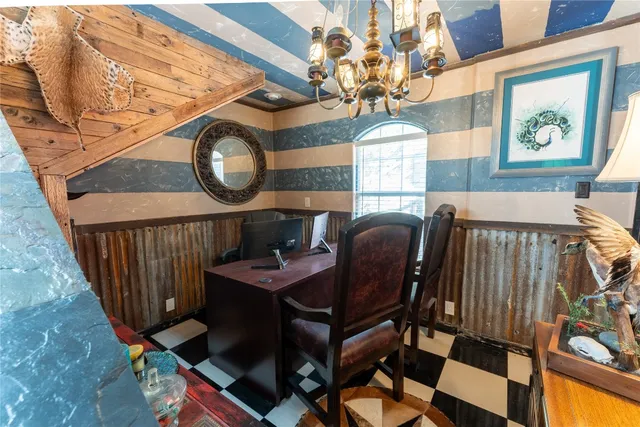 a view of a dining room with furniture and chandelier