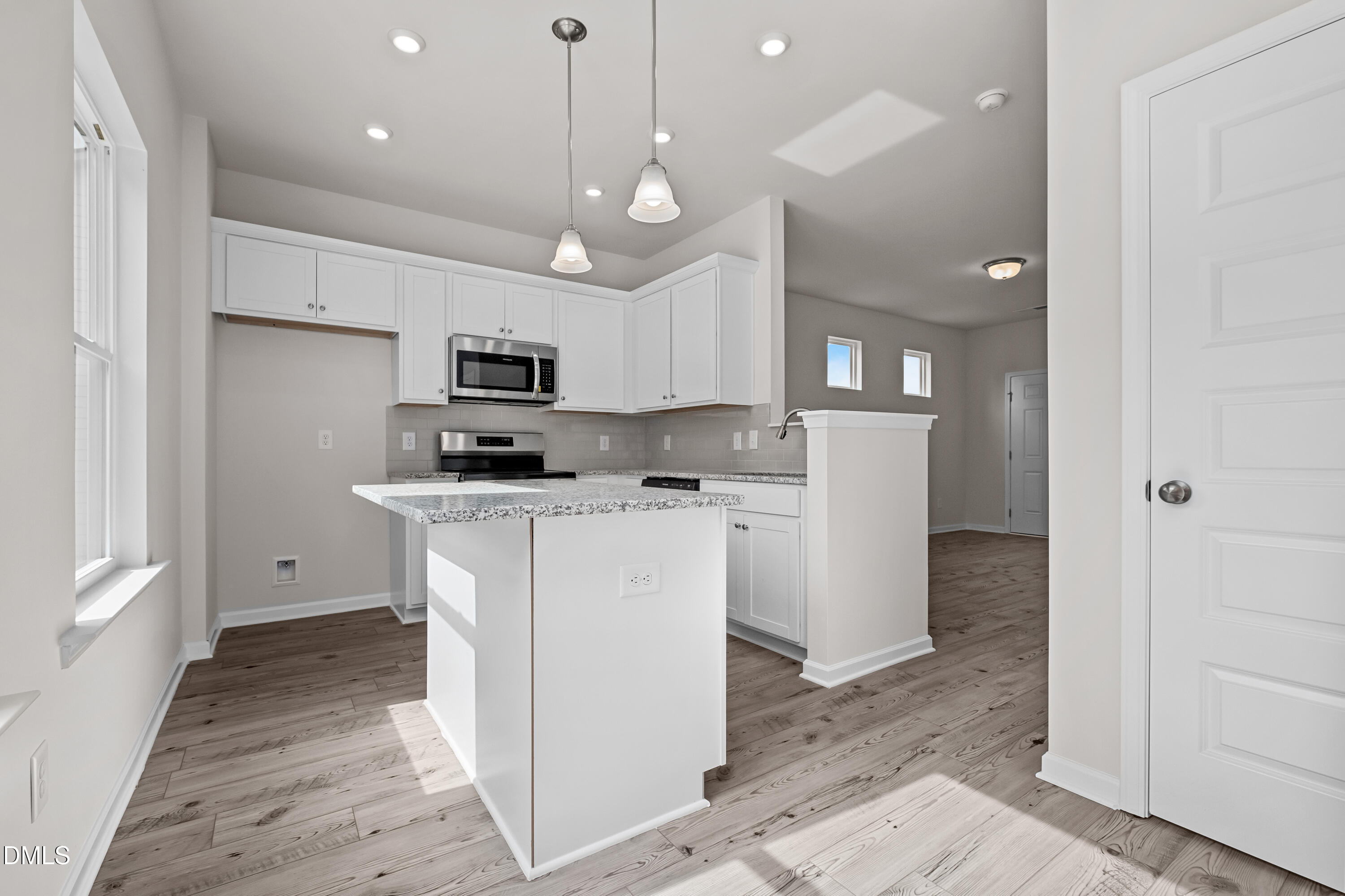 233 Courtside Drive Dunn, NC 28334 - Photo 11 of 29 a kitchen with a refrigerator a microwave and cabinets