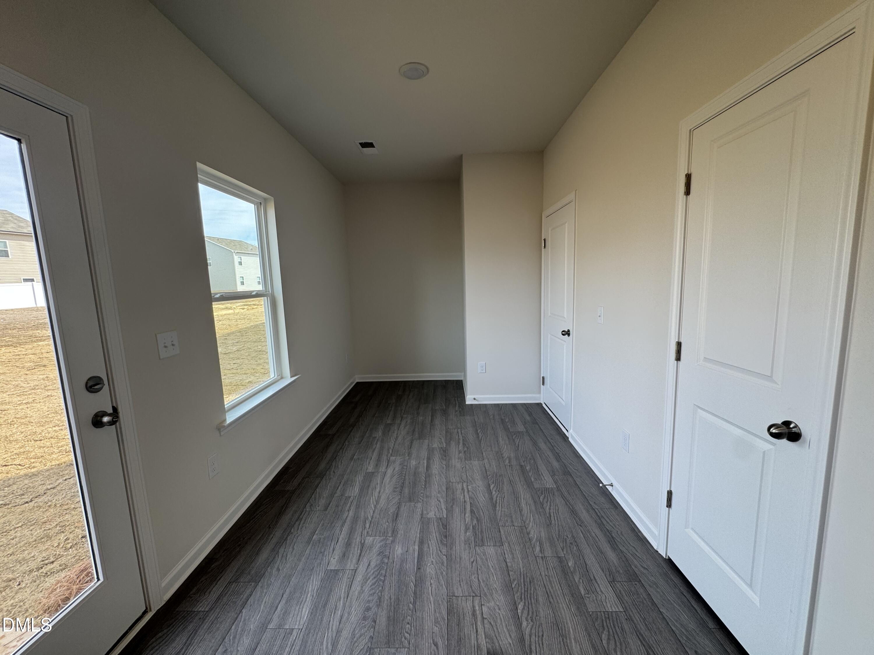 233 Courtside Drive Dunn, NC 28334 - Photo 12 of 29 a view of an empty room with wooden floor and a window