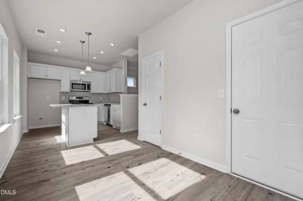 a kitchen with a refrigerator and a stove top oven