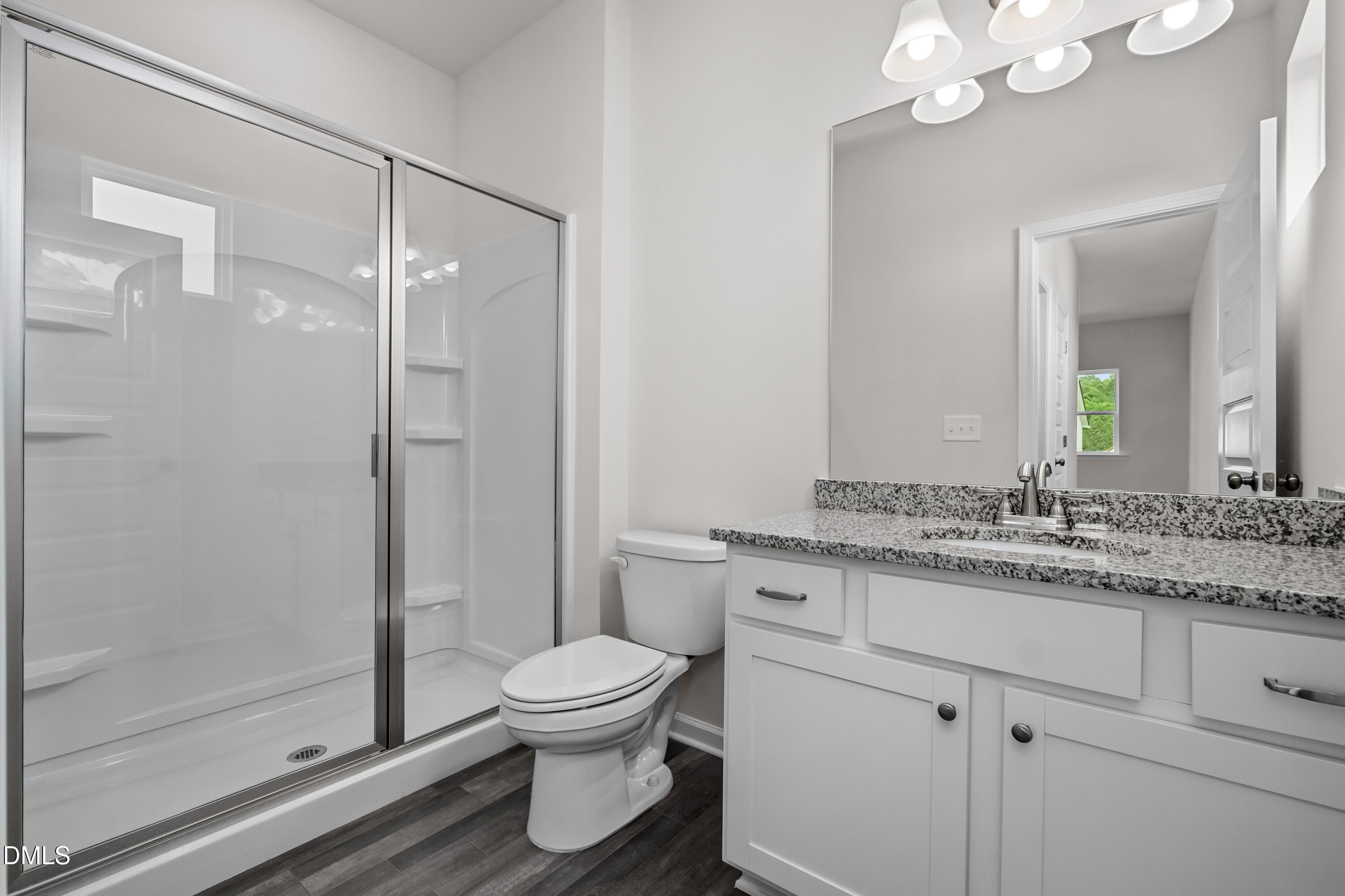 233 Courtside Drive Dunn, NC 28334 - Photo 19 of 29 a bathroom with a granite countertop sink a toilet and a mirror