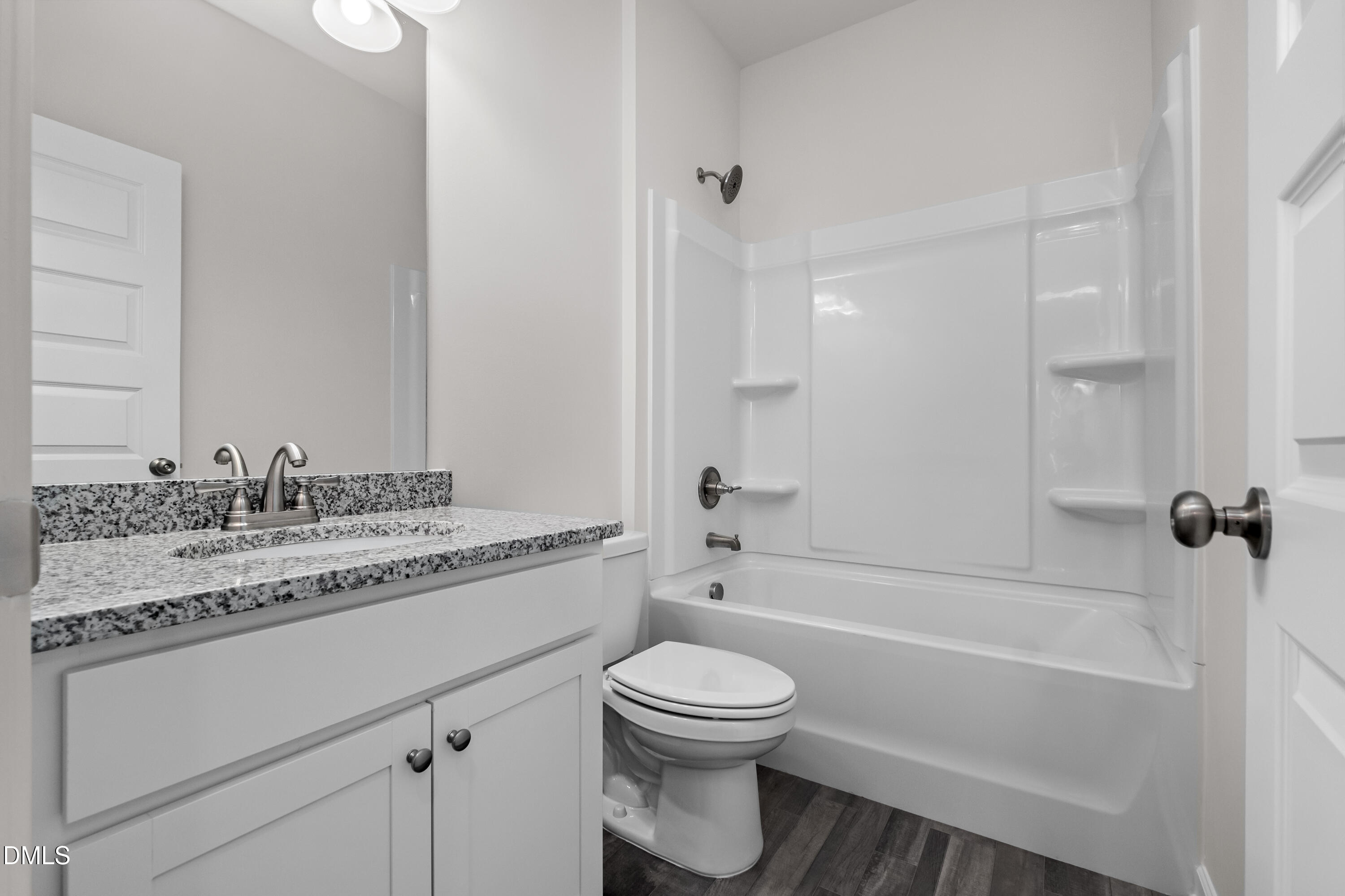 233 Courtside Drive Dunn, NC 28334 - Photo 23 of 29 a bathroom with a granite countertop toilet a sink and a bathtub