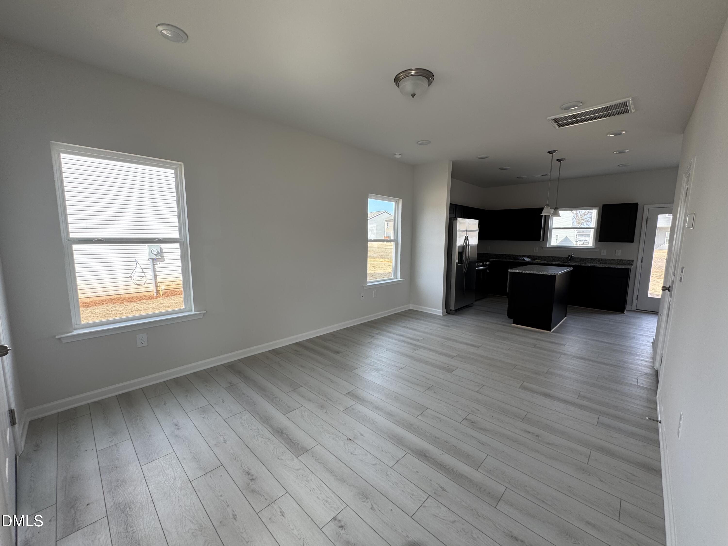 233 Courtside Drive Dunn, NC 28334 - Photo 3 of 29 an empty room with wooden floor and windows