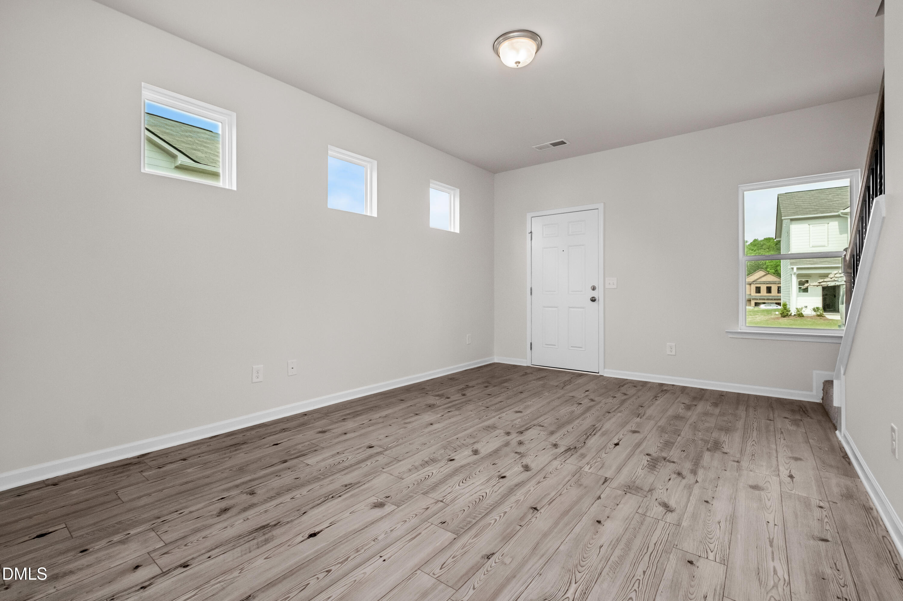 233 Courtside Drive Dunn, NC 28334 - Photo 7 of 29 an empty room with wooden floor and windows