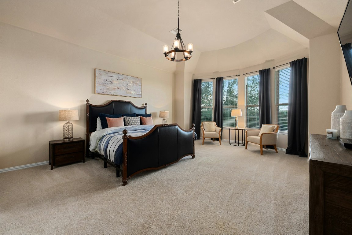 8804 Flycatcher Court Austin, TX 78738 - Photo 12 of 39 a bedroom with a bed couch and a large window