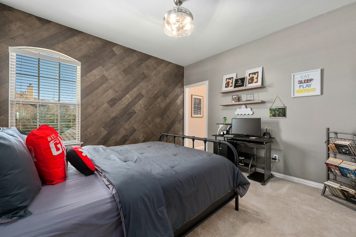 8804 Flycatcher Court Austin, TX 78738 - Photo 20 of 39 a bedroom with a bed and a window