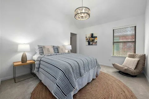 a bedroom with bed and window