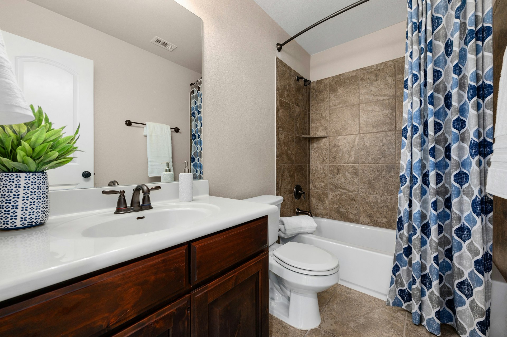 8804 Flycatcher Court Austin, TX 78738 - Photo 24 of 39 a bathroom with a sink a toilet a mirror and shower