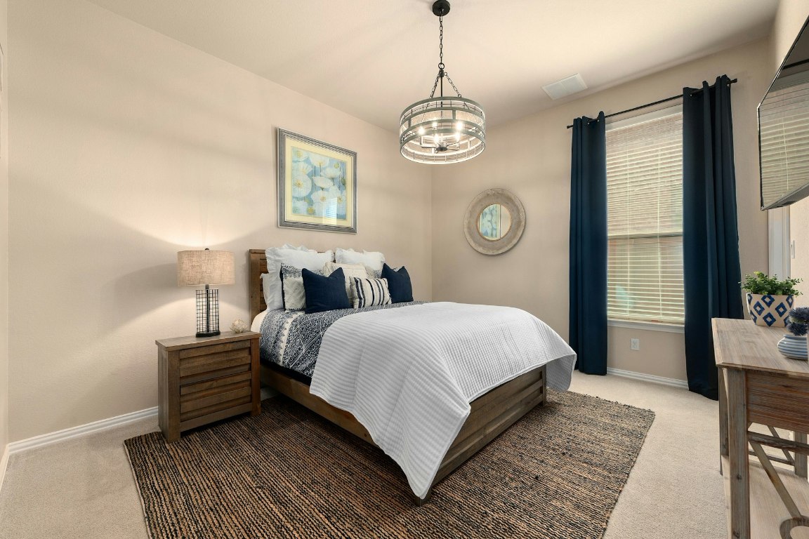 8804 Flycatcher Court Austin, TX 78738 - Photo 25 of 39 a bedroom with a bed and window