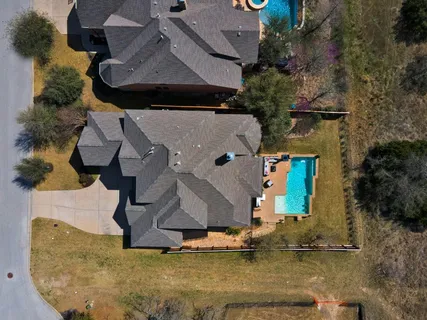 an aerial view of a house with a yard