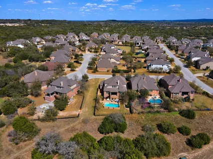 an aerial view of residential houses with outdoor space