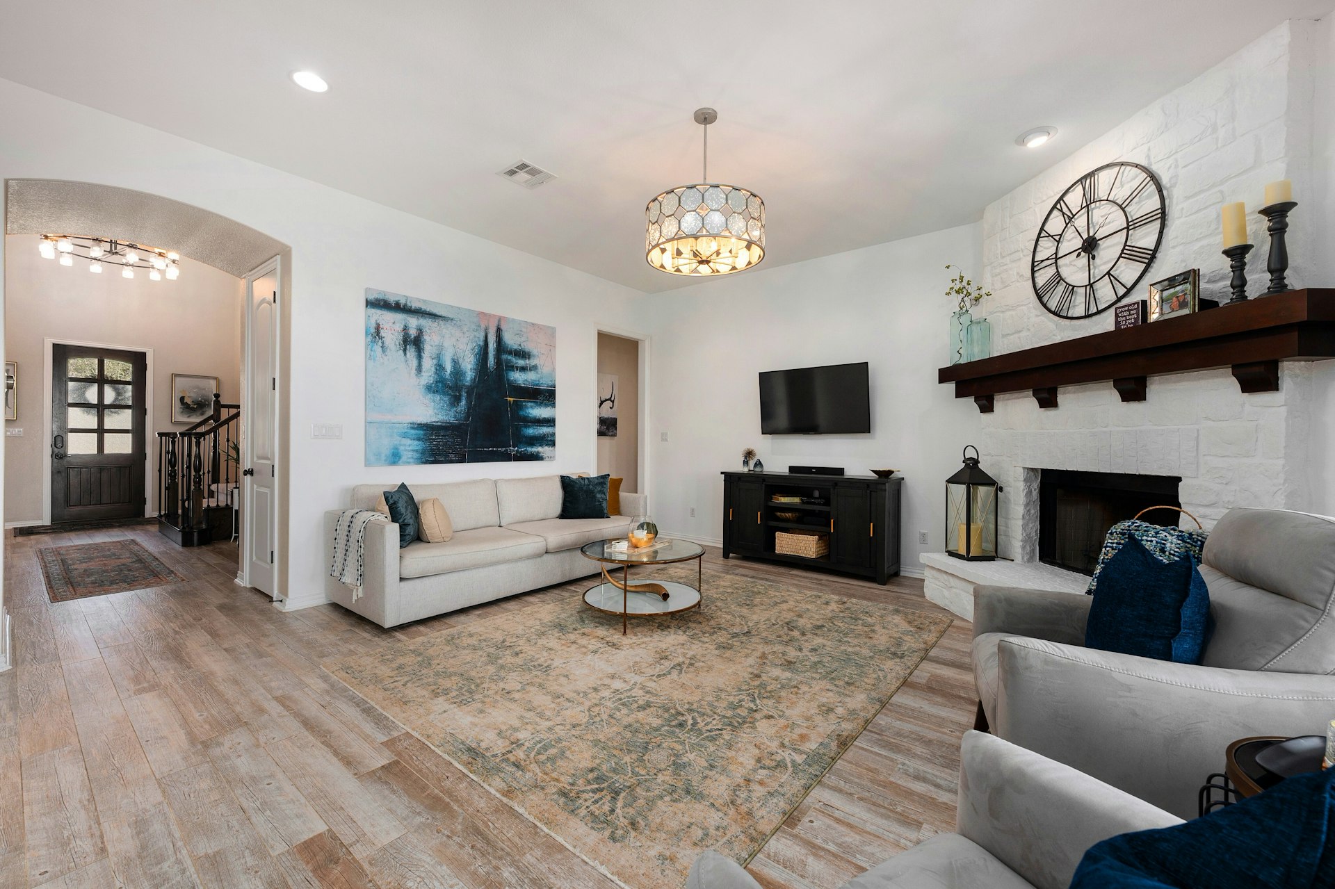 8804 Flycatcher Court Austin, TX 78738 - Photo 7 of 39 a living room with furniture a fireplace and a flat screen tv