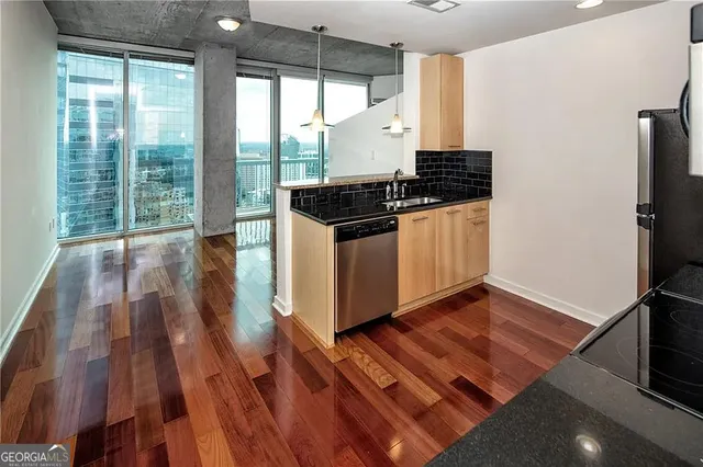 a kitchen with granite countertop a stove and a refrigerator